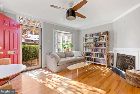 a living room with fireplace furniture and a window