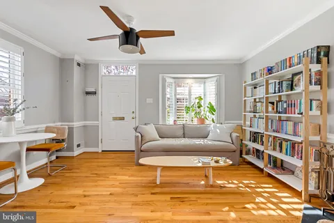 a living room with furniture and a book shelf