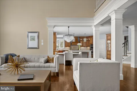 a living room with furniture and a chandelier