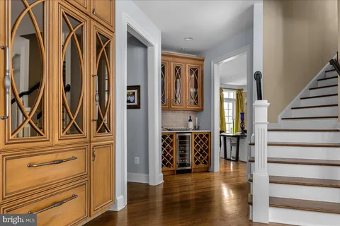 a view of a hallway with wooden floor and entryway