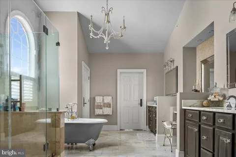 a spacious bathroom with a double vanity sink a mirror and a bathtub