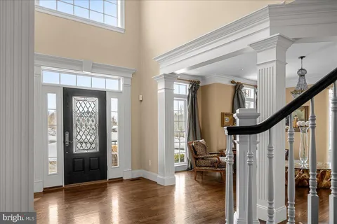 a view of entryway with wooden floor and stairs