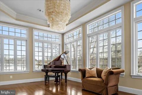 a living room with furniture a wooden floor and a large window