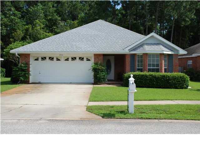 3900 Mesa Road Destin, FL 32541 - Photo 1 of 12 a front view of a house with a garden