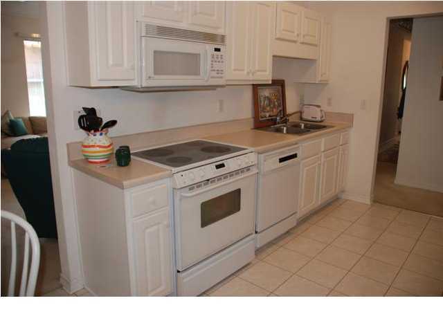 3900 Mesa Road Destin, FL 32541 - Photo 4 of 12 a kitchen with stainless steel appliances granite countertop a sink stove and cabinets