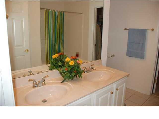 3900 Mesa Road Destin, FL 32541 - Photo 9 of 12 a bathroom with a sink and a mirror