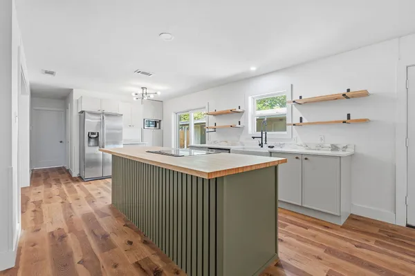 a kitchen with stainless steel appliances granite countertop a sink and cabinets
