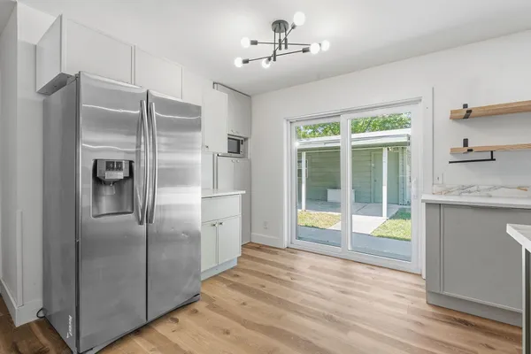 a kitchen with stainless steel appliances granite countertop a refrigerator and a sink