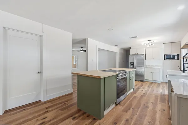 a kitchen with stainless steel appliances granite countertop a stove and a refrigerator