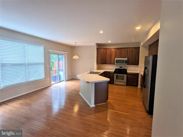 a kitchen with a refrigerator and a stove top oven