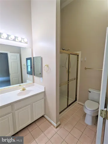 a spacious bathroom with a granite countertop sink toilet and shower