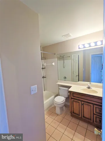 a bathroom with a sink a toilet and a large mirror