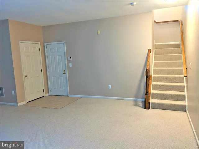 a view of an empty room with stairs