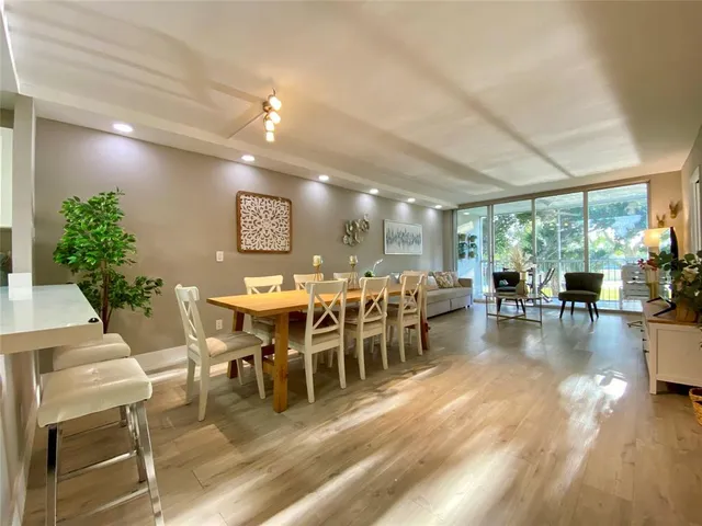 a view of a dining room with furniture window and wooden floor