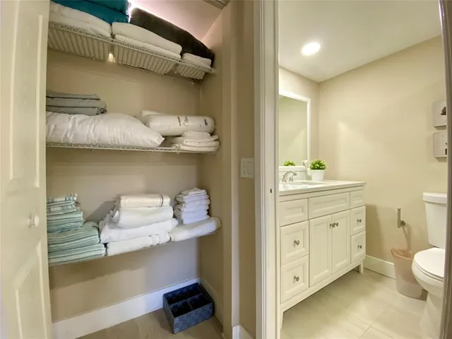 a bathroom with a granite countertop toilet sink and shower