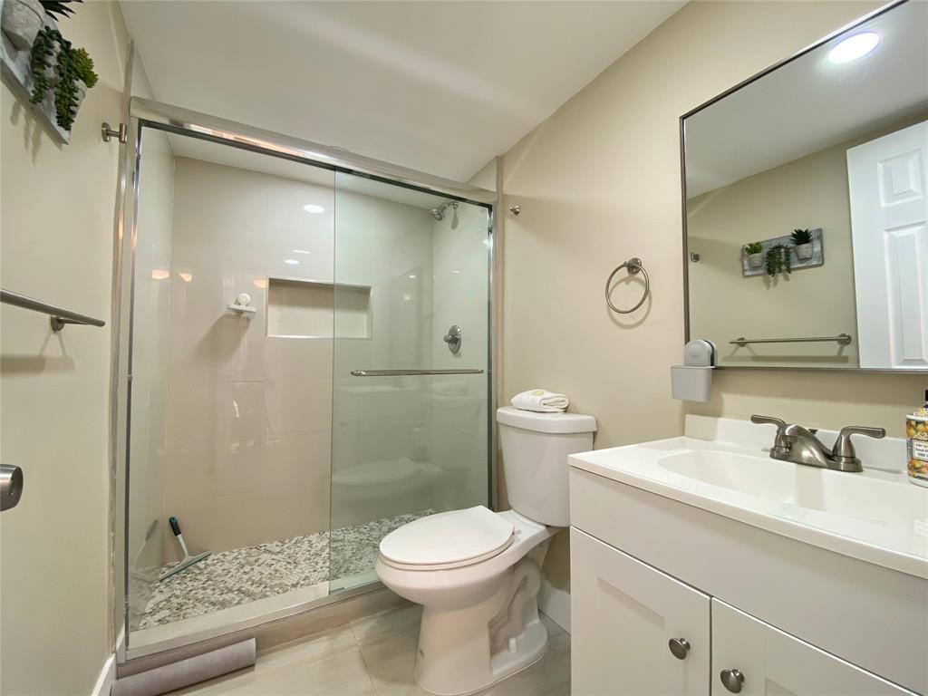 3010 North Course Drive, Unit 209 Pompano Beach, FL 33069 - Photo 23 of 39 a bathroom with a sink a toilet and shower