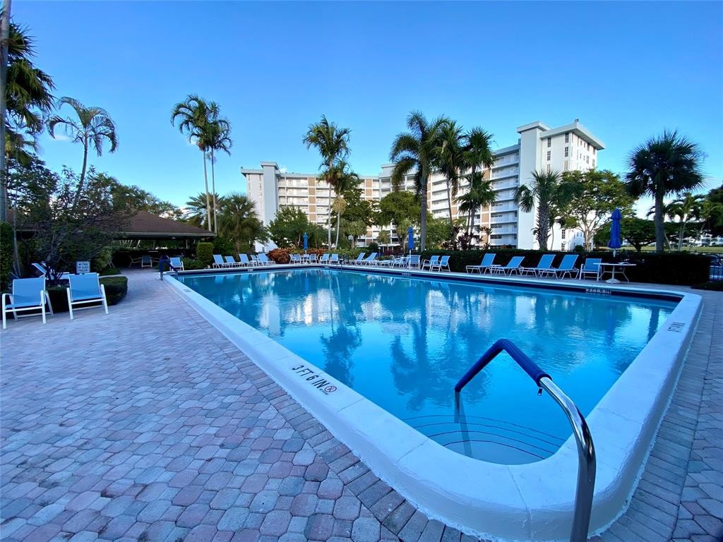 3010 North Course Drive, Unit 209 Pompano Beach, FL 33069 - Photo 31 of 39 a view of a swimming pool with sitting area