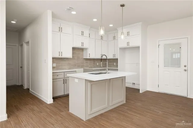 a kitchen with kitchen island white cabinets and white appliances
