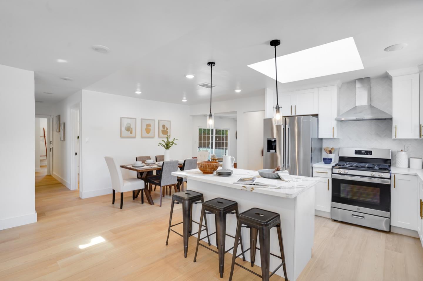 3649 Rowley Drive San Jose, CA 95132 - Photo 8 of 49 a kitchen with stainless steel appliances kitchen island granite countertop a dining table and chairs