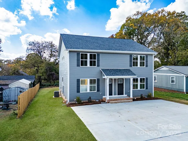 a front view of a house with a garden and yard
