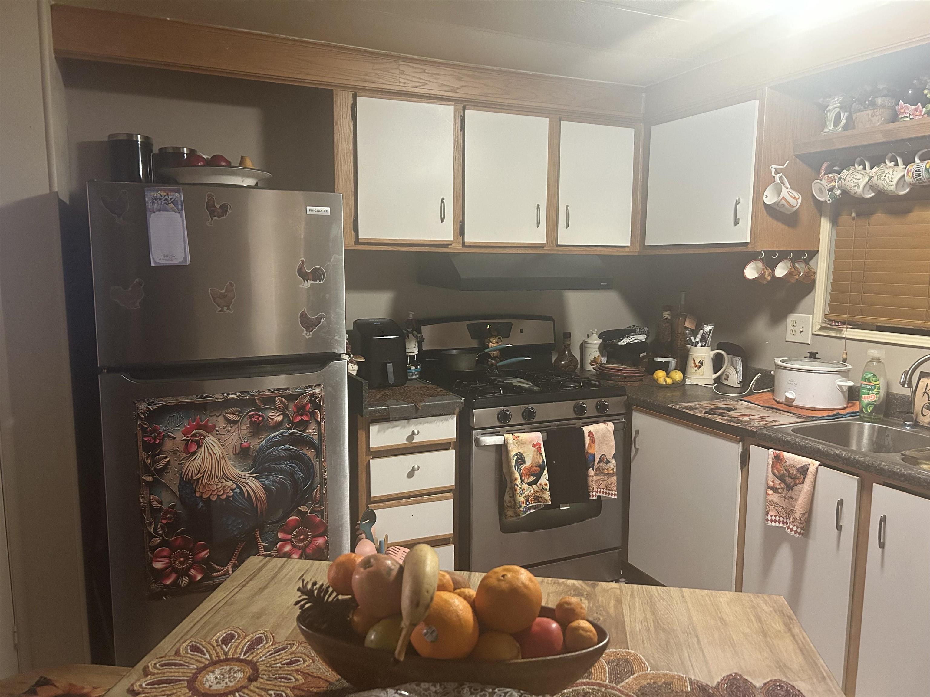 3901 Lake Road, Unit 68 West Sacramento, CA 95691 - Photo 3 of 15 a kitchen with stainless steel appliances granite countertop a refrigerator a sink a stove and a microwave