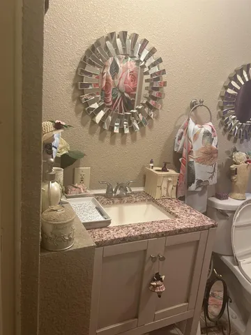 a bedroom with a bed and a night stand