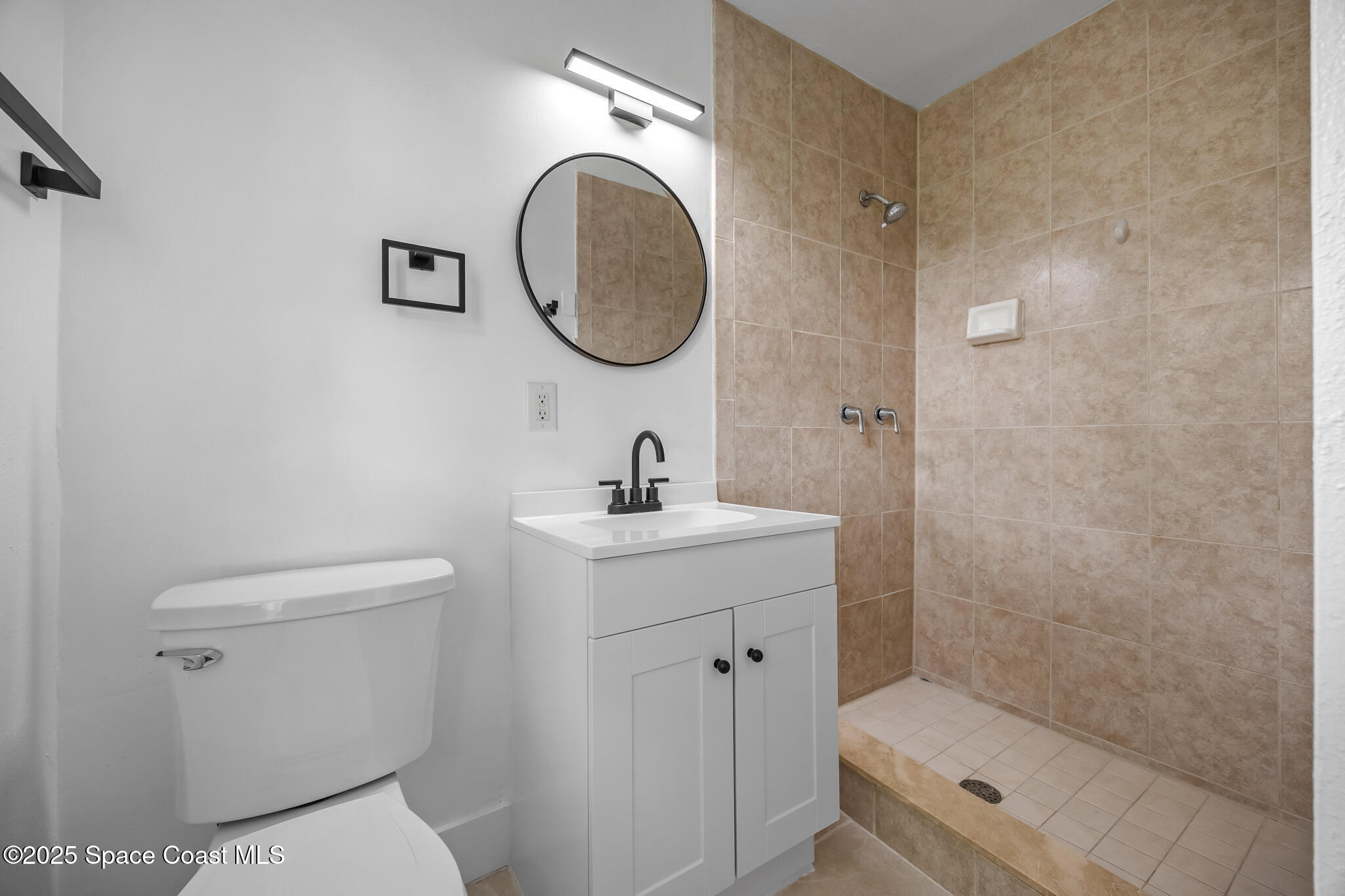 287 Edward Road Melbourne, FL 32904 - Photo 12 of 22 a bathroom with a toilet sink and a mirror