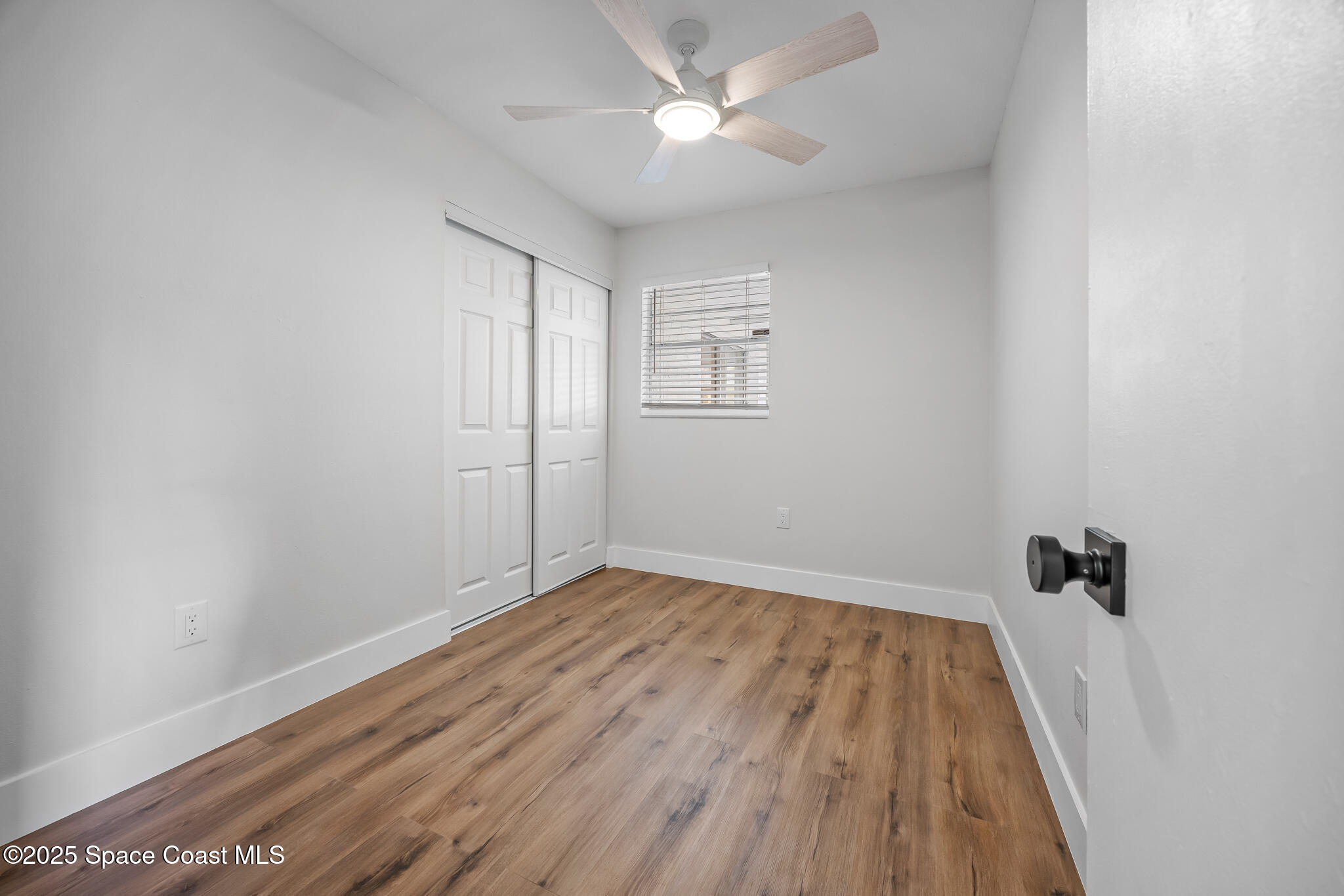 287 Edward Road Melbourne, FL 32904 - Photo 13 of 22 wooden floor in an empty room with a window