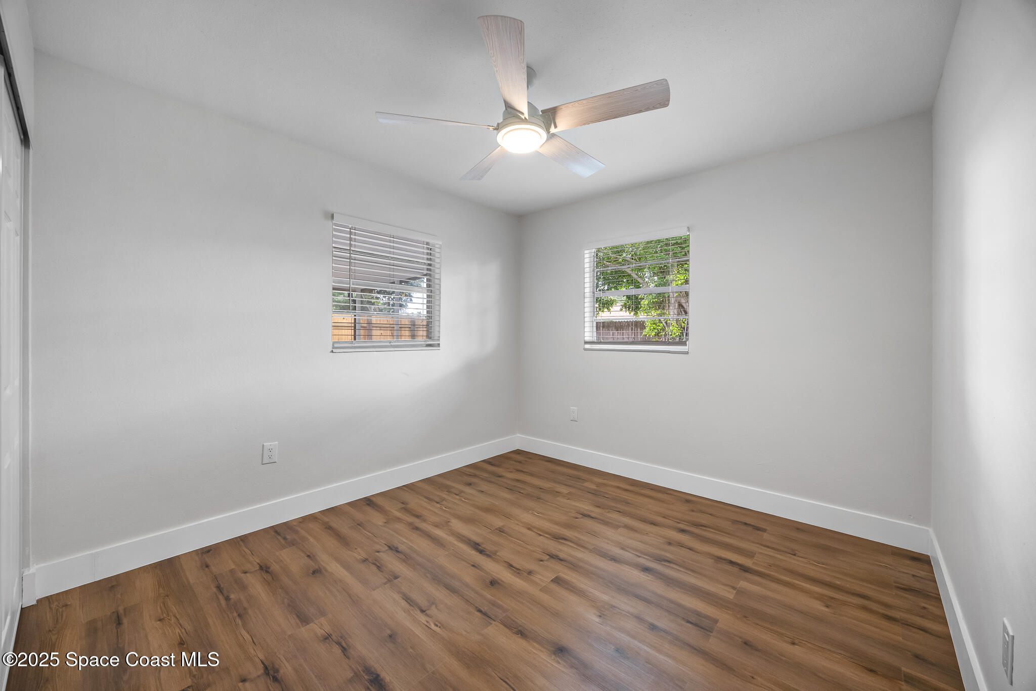 287 Edward Road Melbourne, FL 32904 - Photo 14 of 22 an empty room with wooden floor and windows