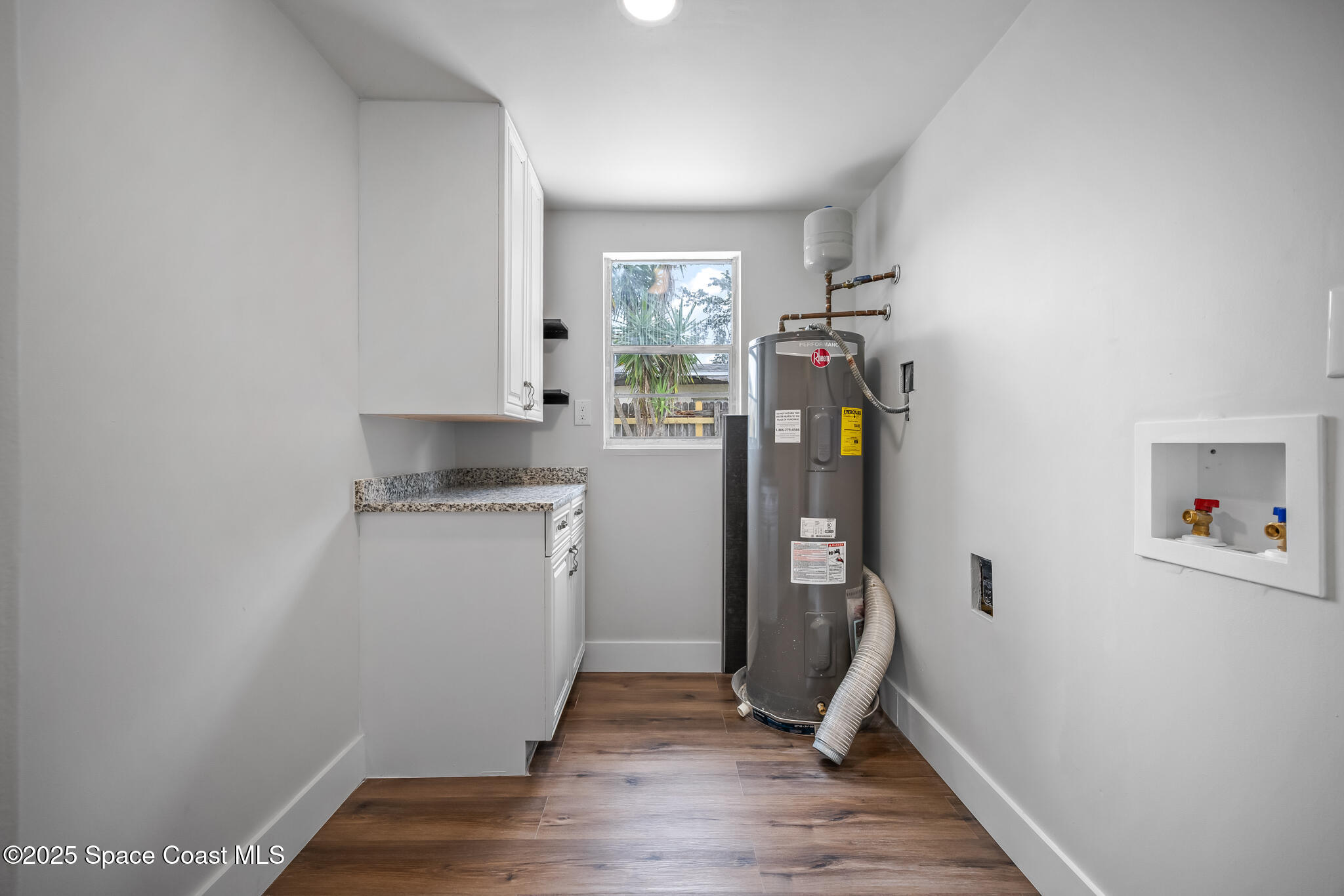 287 Edward Road Melbourne, FL 32904 - Photo 16 of 22 a view of room with wooden floor and stairs