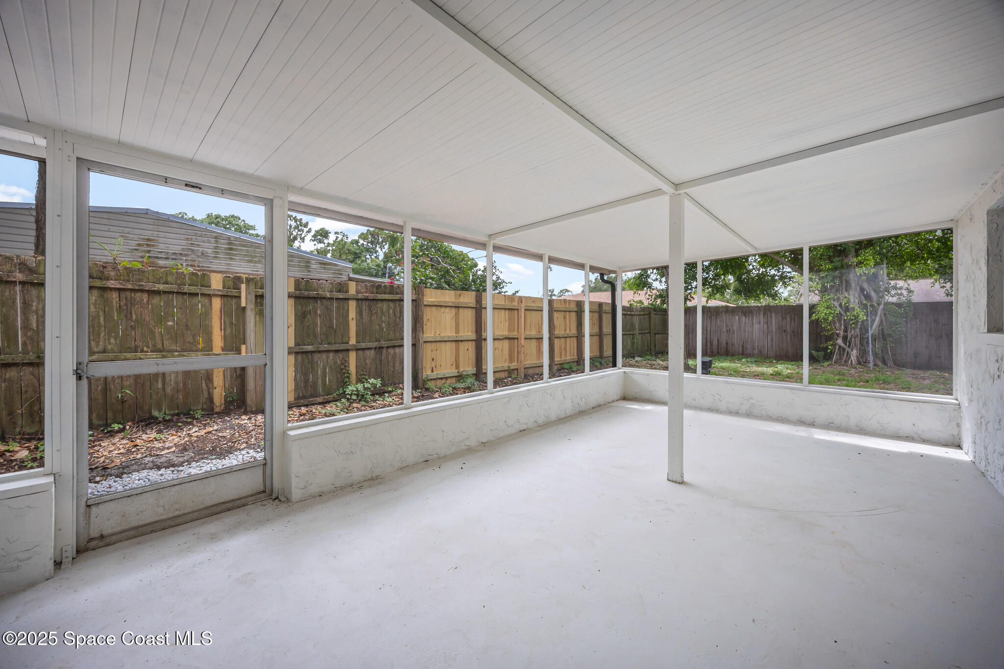 287 Edward Road Melbourne, FL 32904 - Photo 17 of 22 a view of an empty room with a sliding door