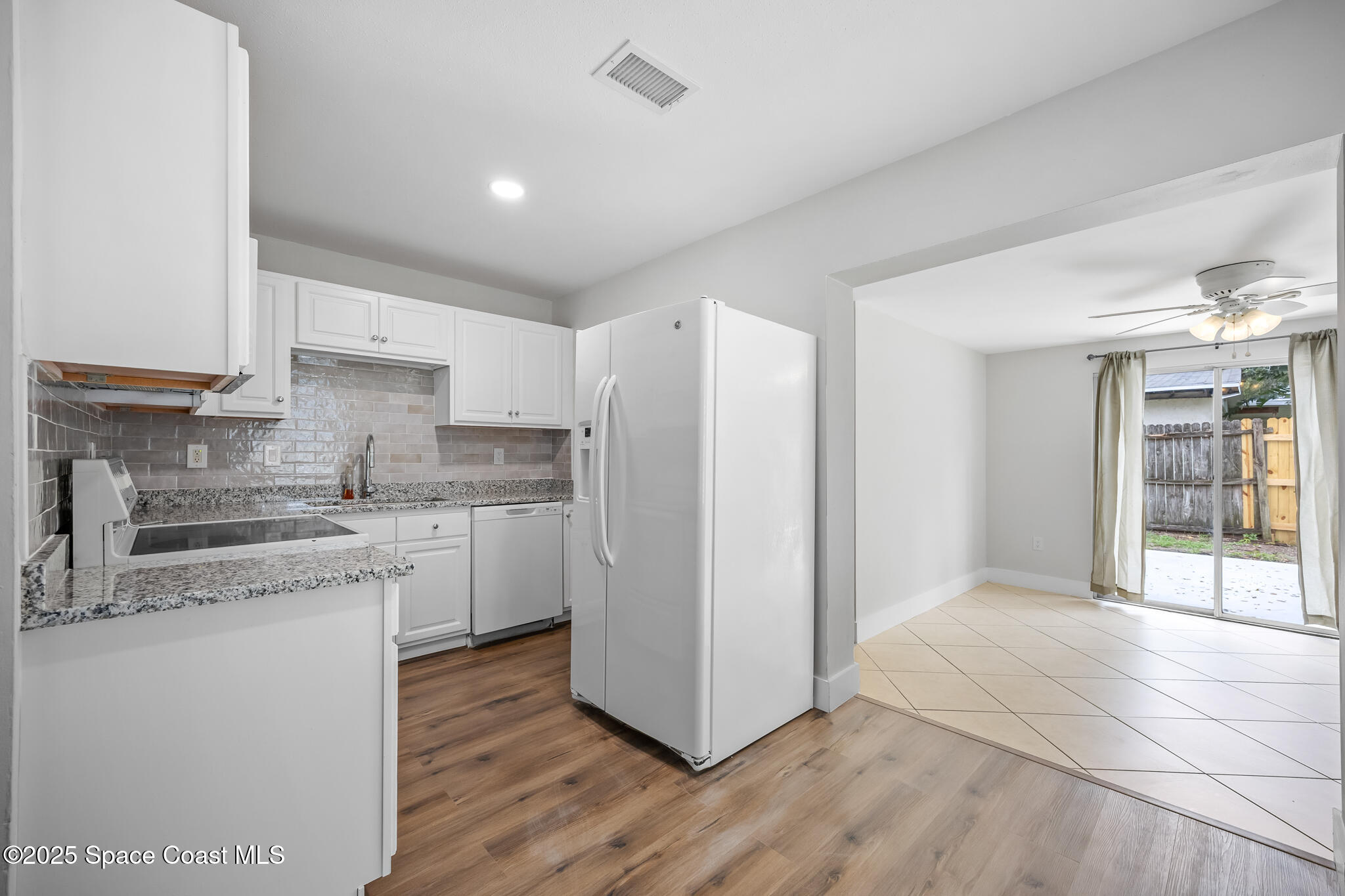287 Edward Road Melbourne, FL 32904 - Photo 3 of 22 a kitchen with a sink cabinets stainless steel appliances and view living room