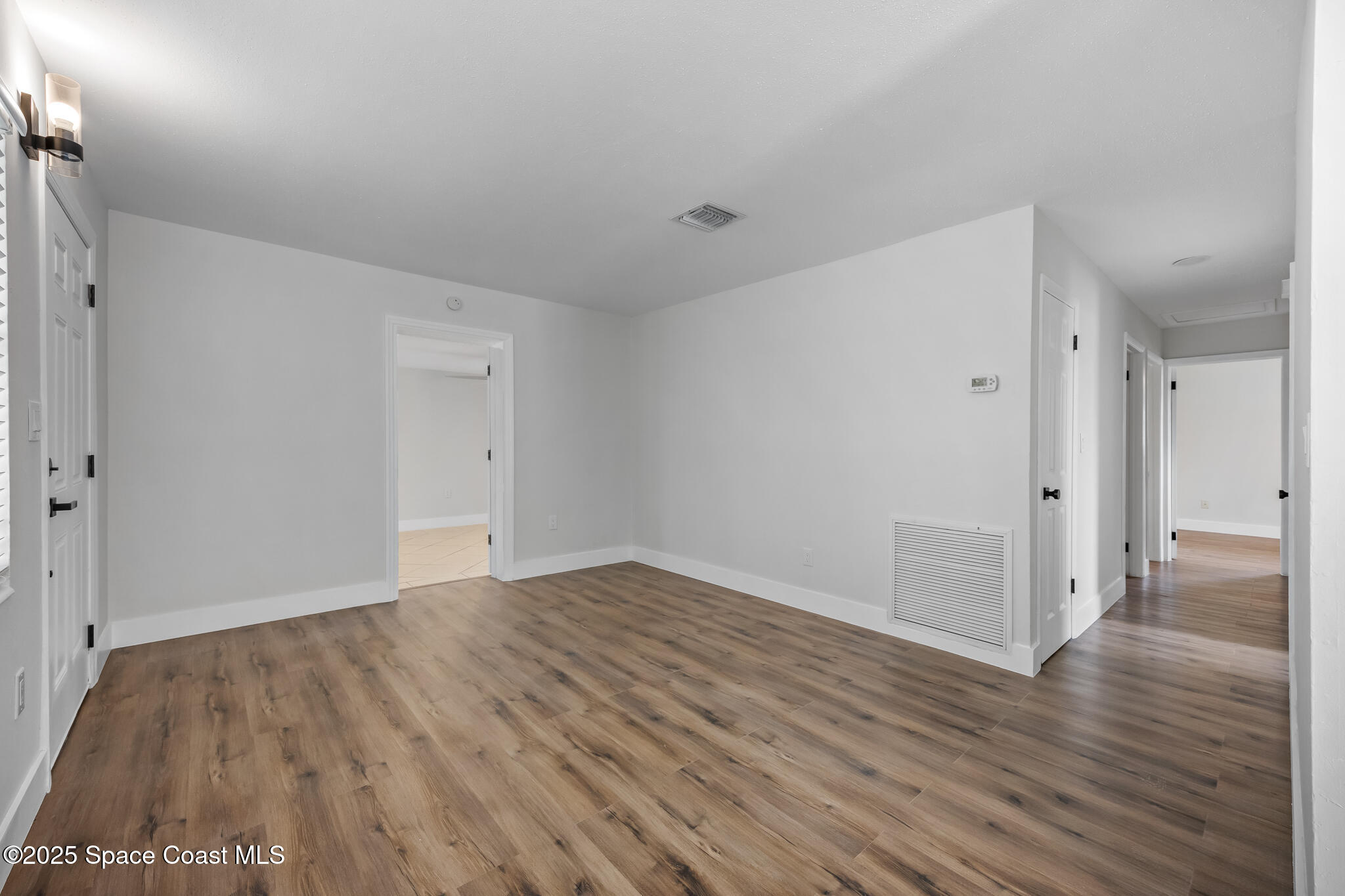 287 Edward Road Melbourne, FL 32904 - Photo 5 of 22 a view of an empty room with wooden floor