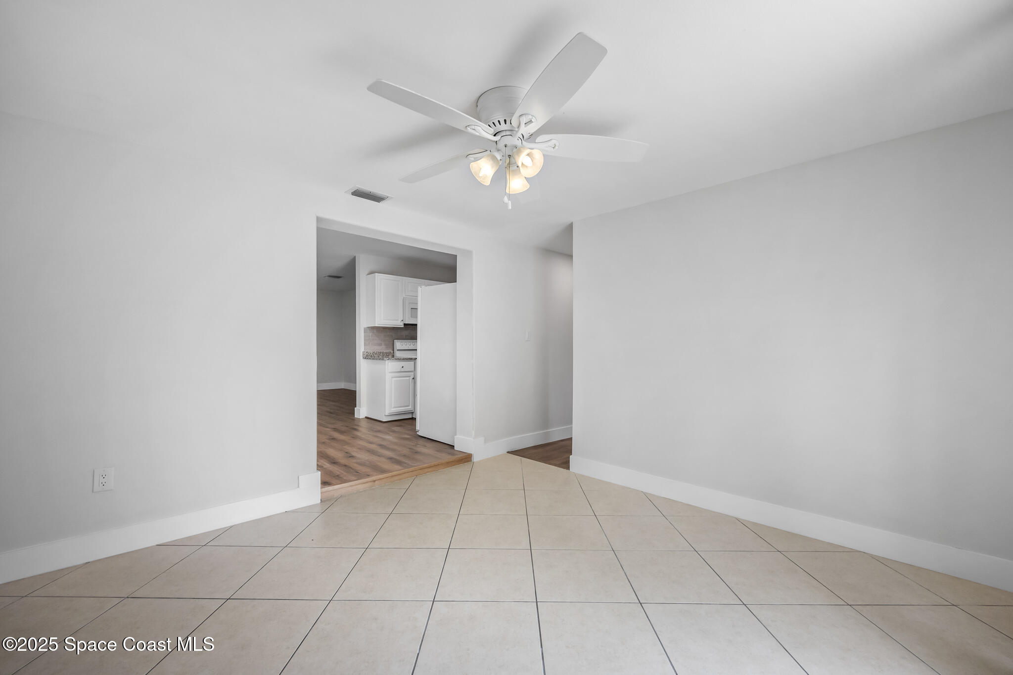 287 Edward Road Melbourne, FL 32904 - Photo 7 of 22 a view of an empty room with closet and a chandelier fan