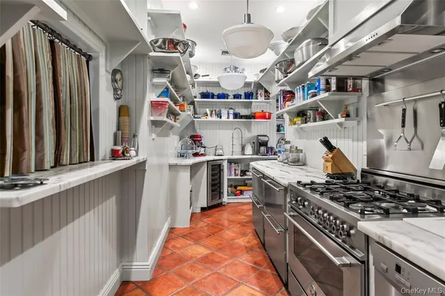 a kitchen with stainless steel appliances granite countertop a stove and a sink