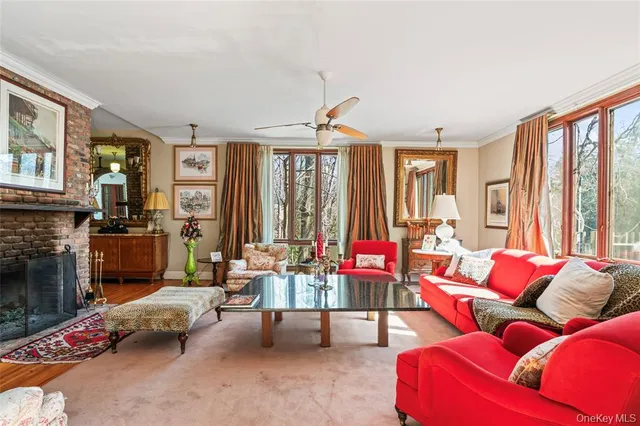 a living room with furniture ceiling fan and a fireplace