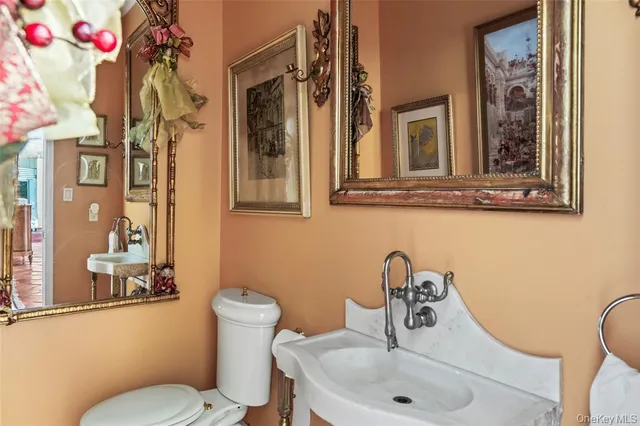 a bathroom with a toilet sink and mirror