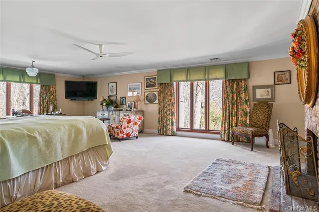 a bedroom with a bed couch and a large window