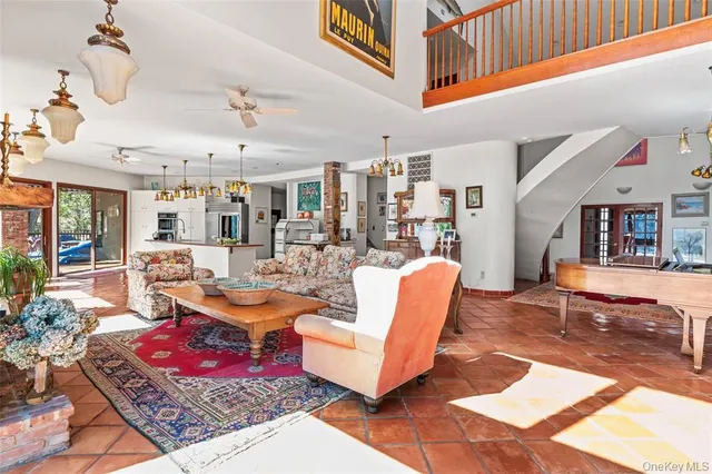a living room with lots of furniture and view of kitchen