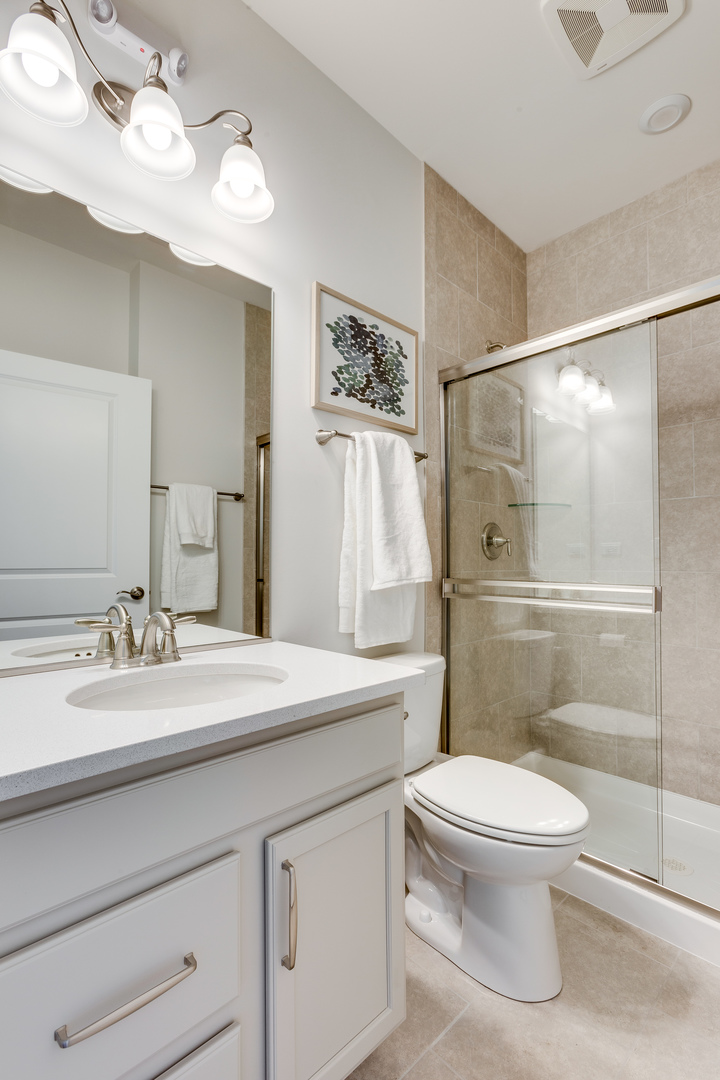 825 Spring Drive Lindenhurst, IL 60046 - Photo 24 of 29 a bathroom with a sink a toilet and shower