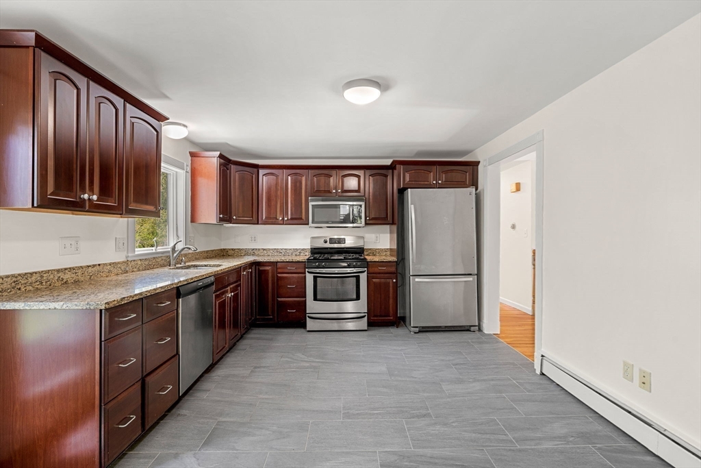 2 Mark Street Manchester, MA 01944 - Photo 14 of 33 a kitchen with stainless steel appliances granite countertop a refrigerator stove a sink and dishwasher