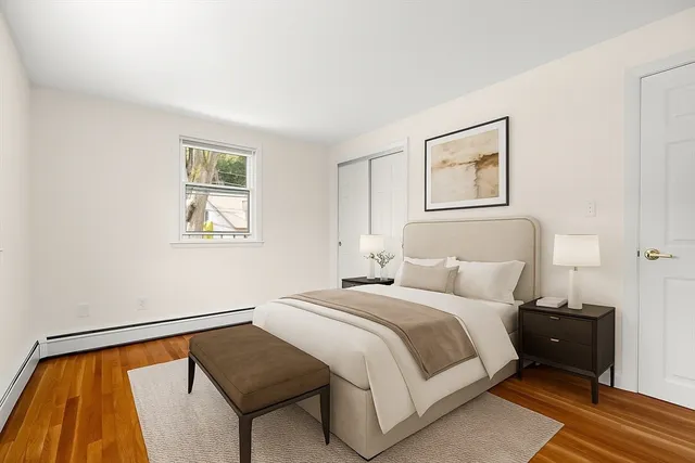 a bedroom with a bed and a painting on the wall