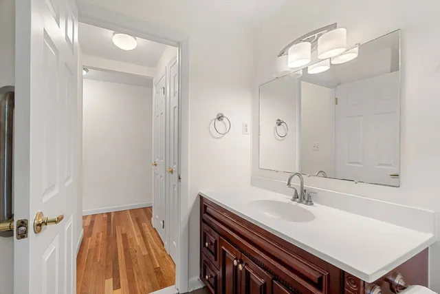 a bathroom with a sink a light fixture and a mirror