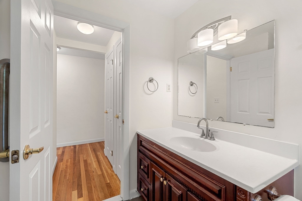 2 Mark Street Manchester, MA 01944 - Photo 19 of 33 a bathroom with a sink a light fixture and a mirror
