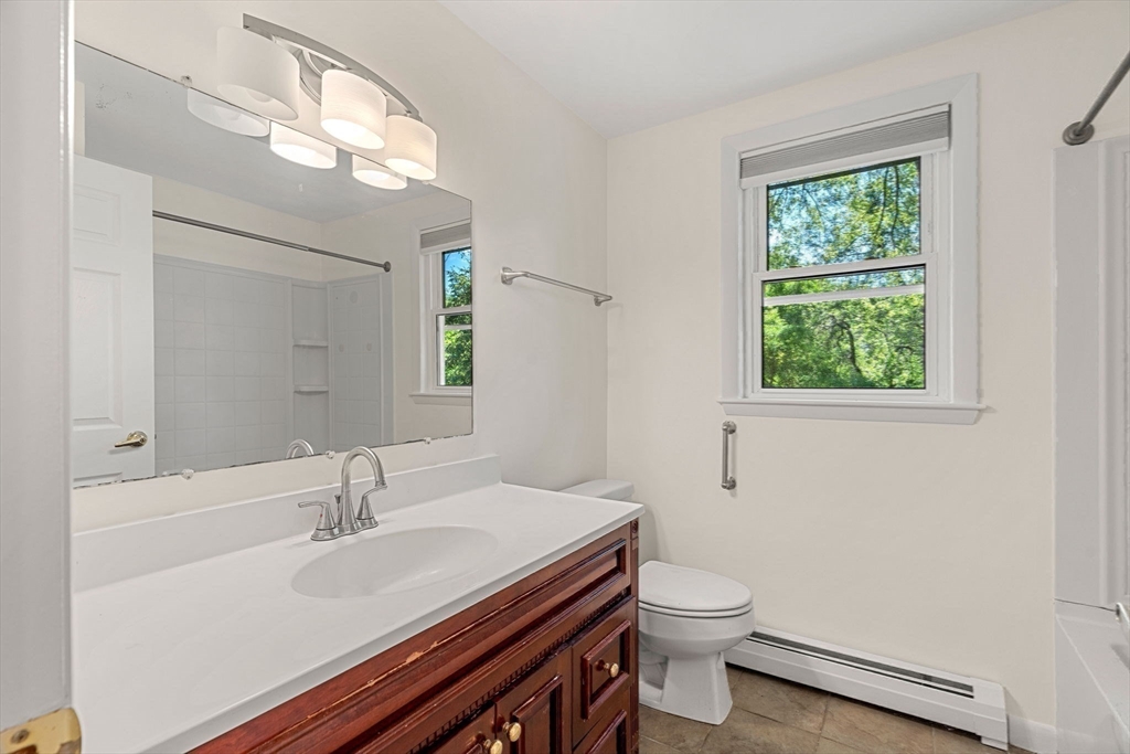 2 Mark Street Manchester, MA 01944 - Photo 20 of 33 a bathroom with a granite countertop sink toilet a large mirror and a window