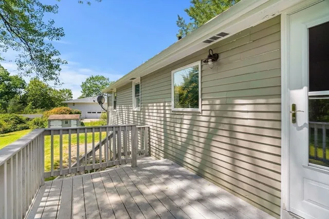 a view of a balcony with yard