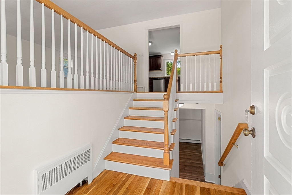 2 Mark Street Manchester, MA 01944 - Photo 5 of 33 a view of entryway with wooden floor and stairs