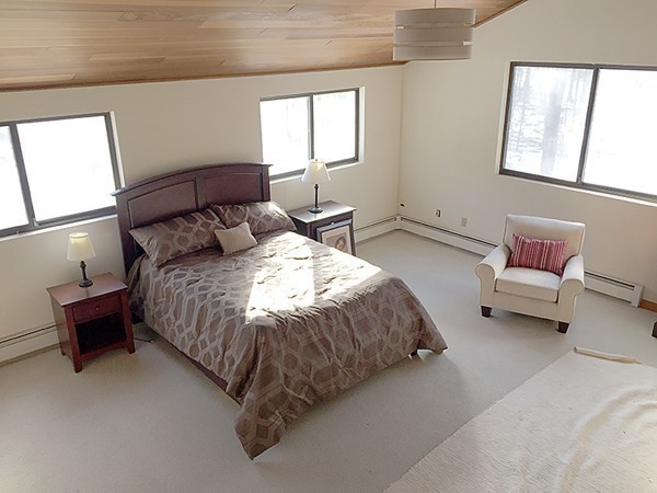 318 Stow Road Harvard, MA 01451 - Photo 13 of 16 a spacious bedroom with a bed and a couch
