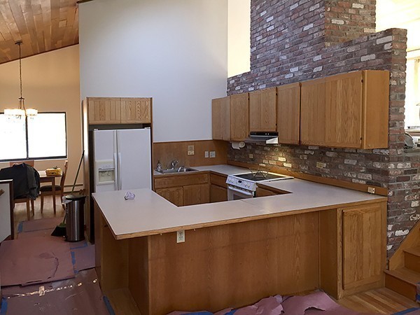 318 Stow Road Harvard, MA 01451 - Photo 6 of 16 a kitchen with a sink a stove and a refrigerator