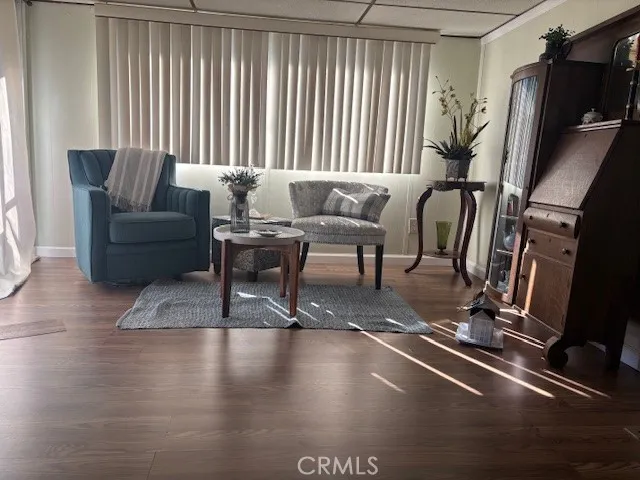 a living room with furniture a flat screen tv and a window